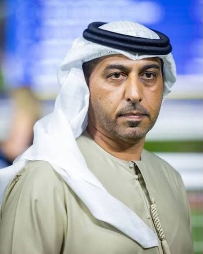 Ahmad Bin Harmash in a white ghutra and beige kandura at the racecourse