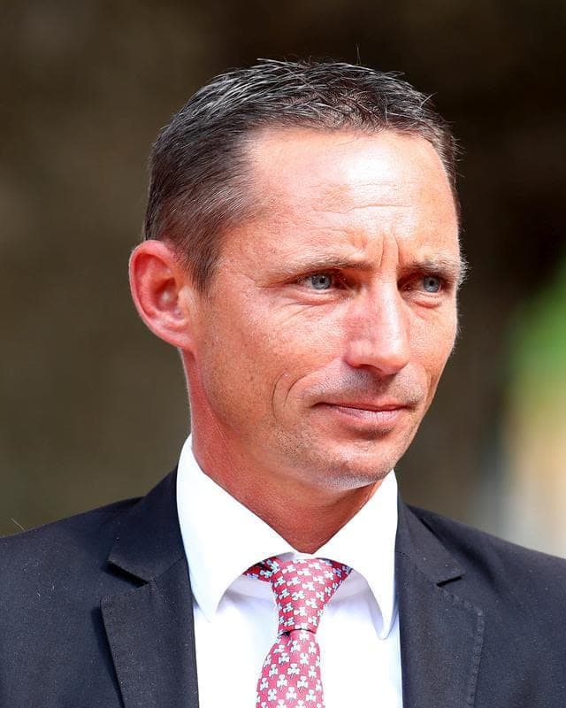 Thomas Fourcy in a dark suit and a pink patterned tie